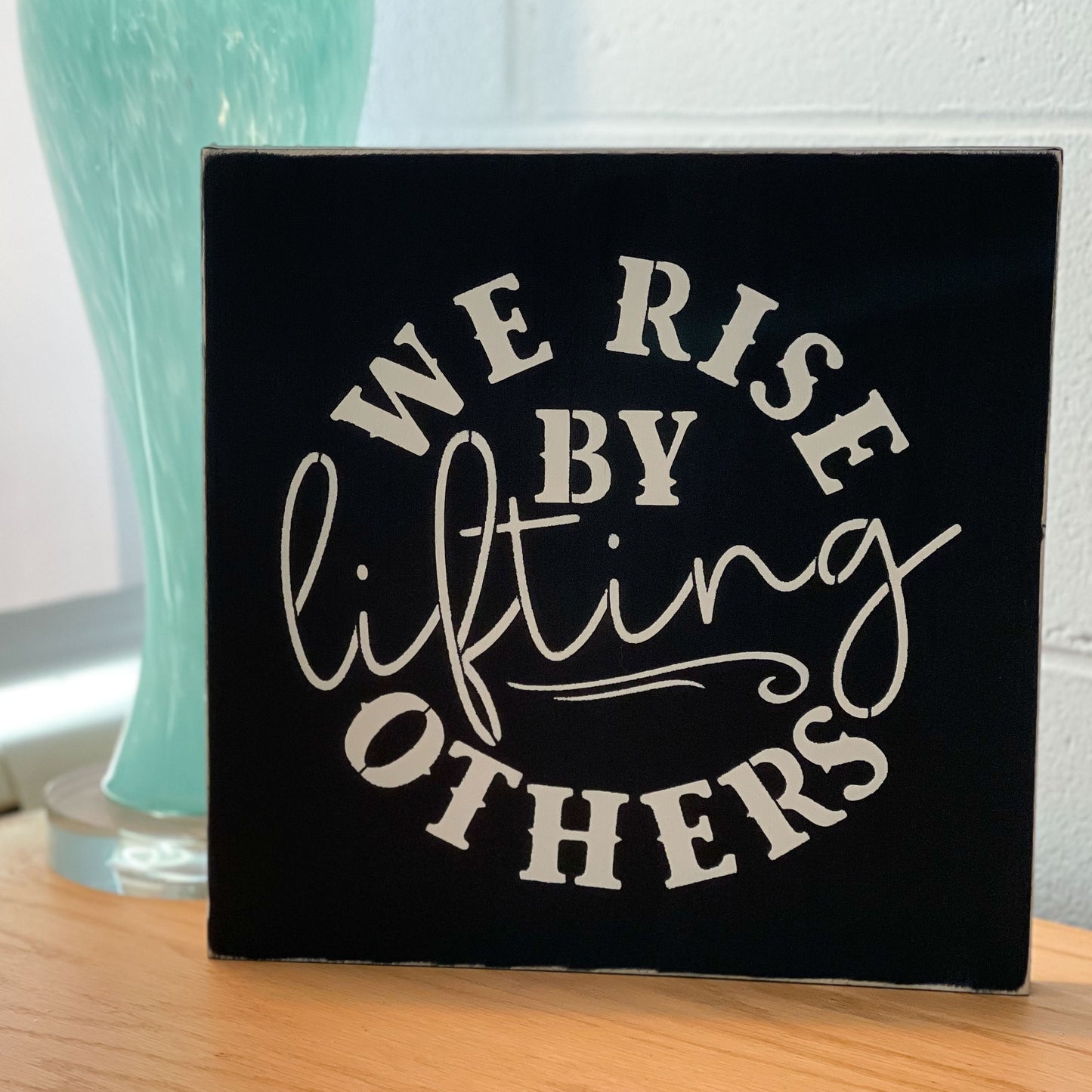 We Rise By Lifting Others Sign